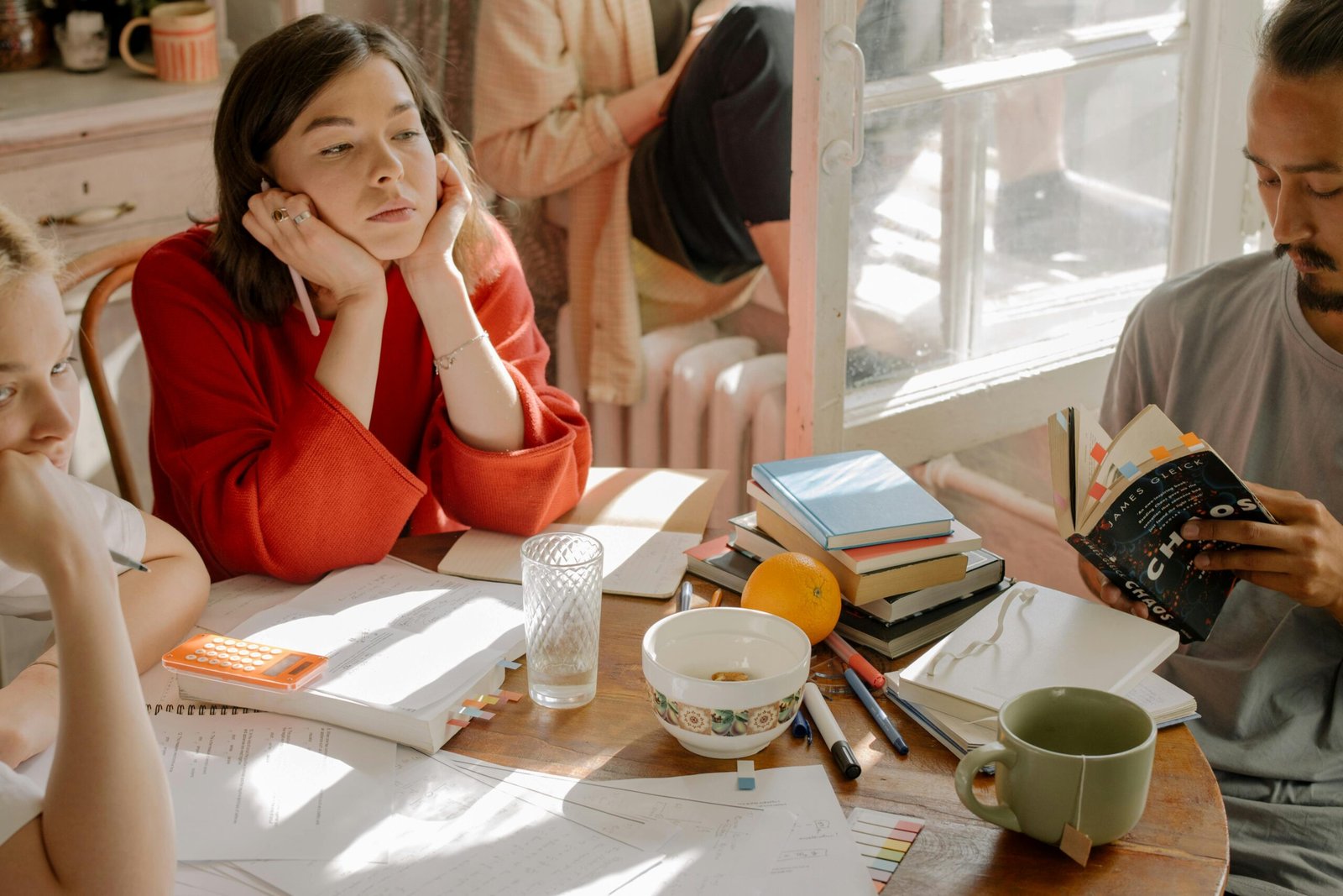 Students studying together around a table with books and notes