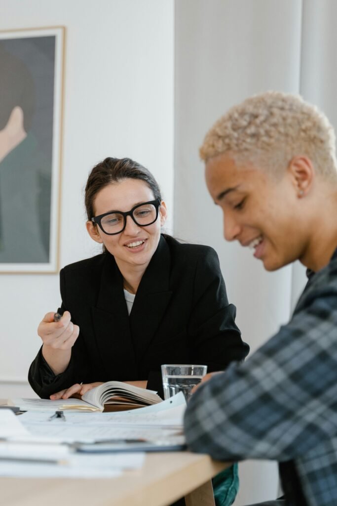 Teacher reviewing study notes with a secondary-school student