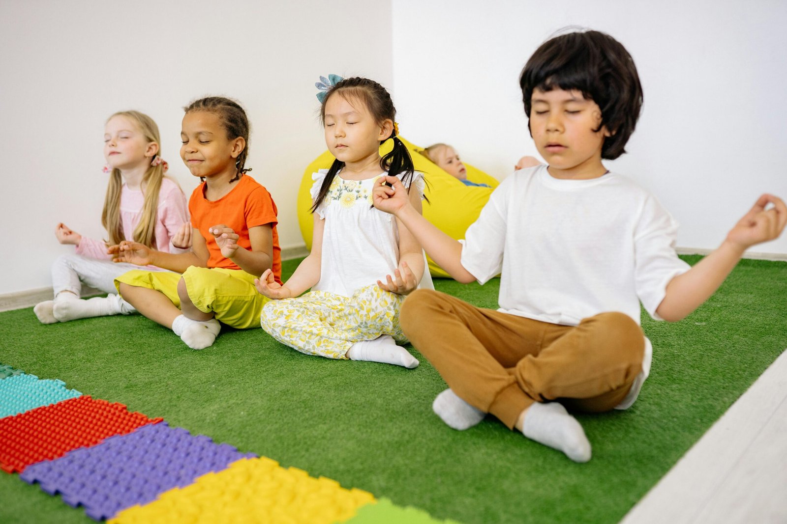 Children practising mindfulness while seated together on the floor