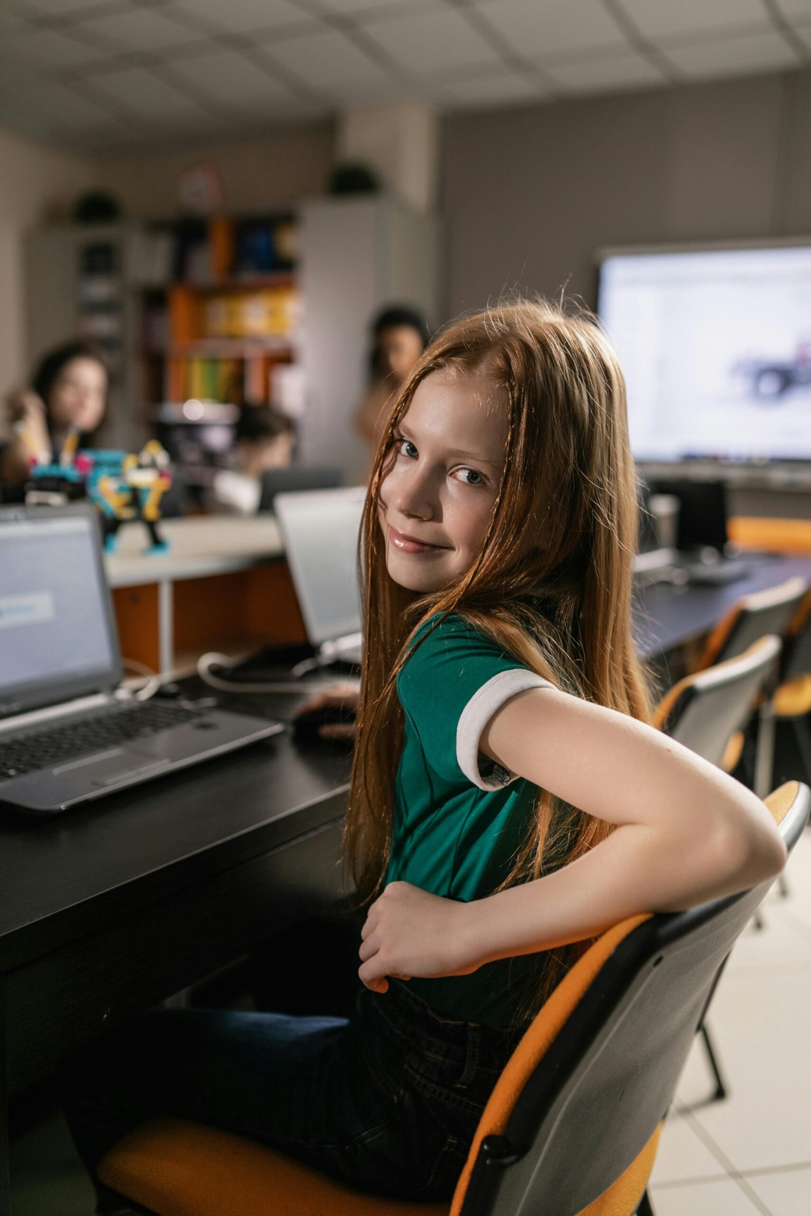 Student using a laptop at her classroom desk